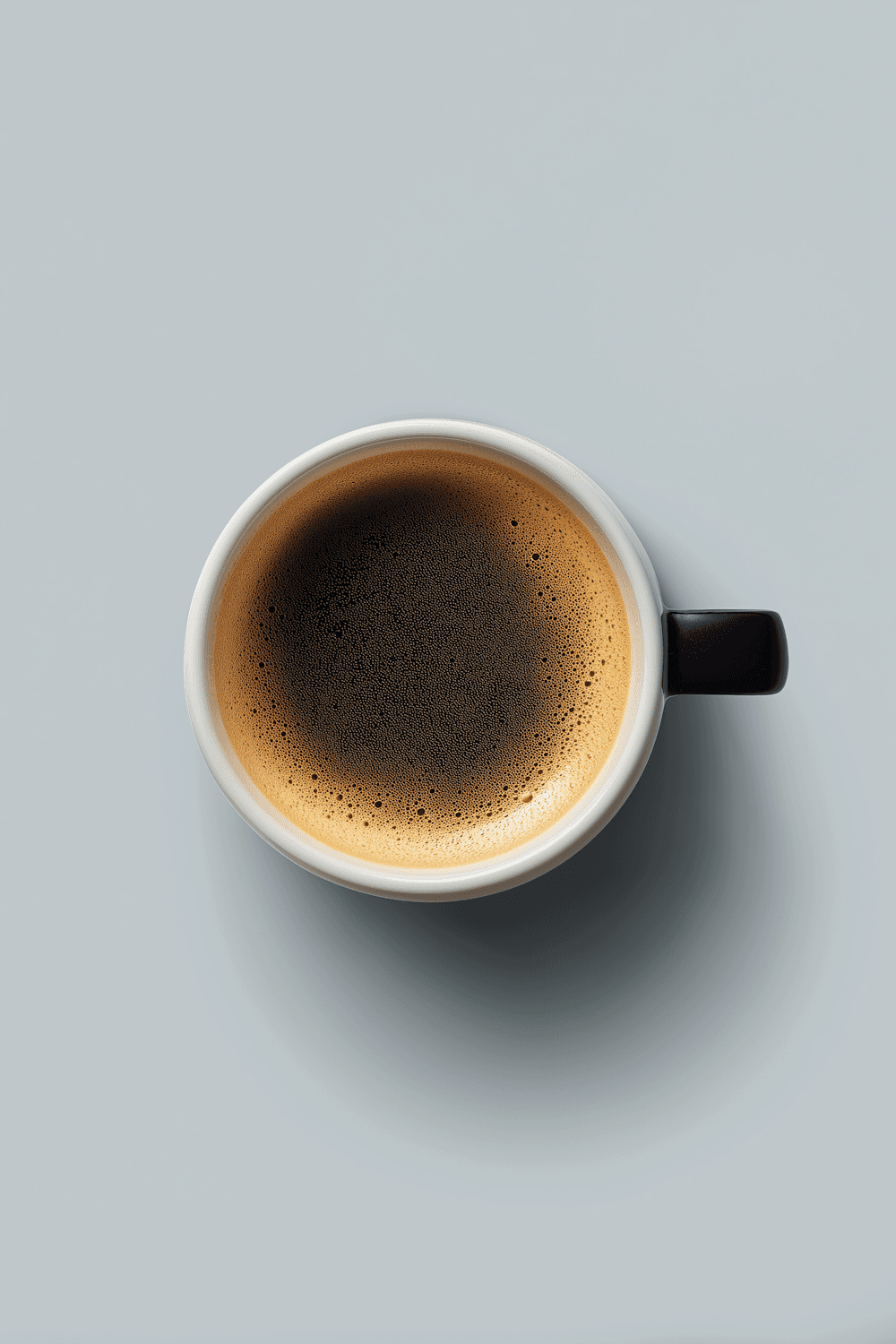 Top-down view of an espresso with rich crema in a white cup